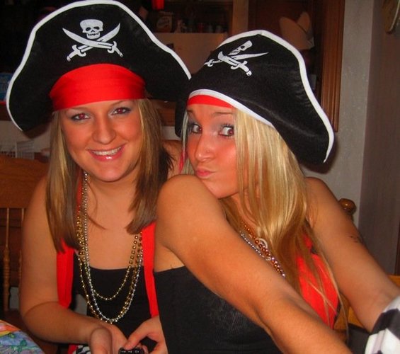 Two young women wearing pirate hats and necklaces