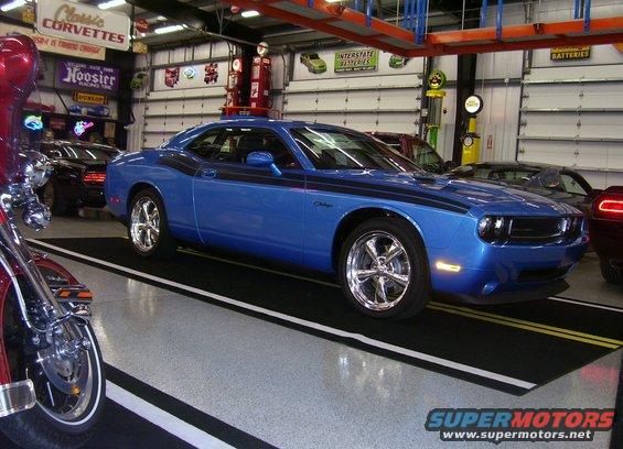 Blue Dodge Challenger with black racing stripes, 3/4 front view