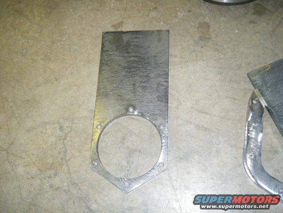 Metal bracket with circular cutout and bolt holes
