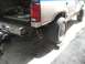 1992 Ford Explorer - Rear view of a beige and blue SUV with a chrome bumper and aftermarket exhaust.