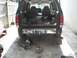1992 Ford Explorer - The rear of a 1995 Ford Explorer is shown with its tailgate open, revealing the cargo area and some tools.