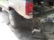 1992 Ford Explorer - The rear section of an SUV is shown, with tools and detached bumper components nearby.