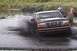 1993 Ford Bronco - A 1993 Ford Bronco navigates a muddy waterway, kicking up a large spray.