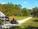 2004 Harley-Davidson FXRT Sport Glide - A rider on a motorcycle is parked on a dirt road next to a white SUV under a tent.