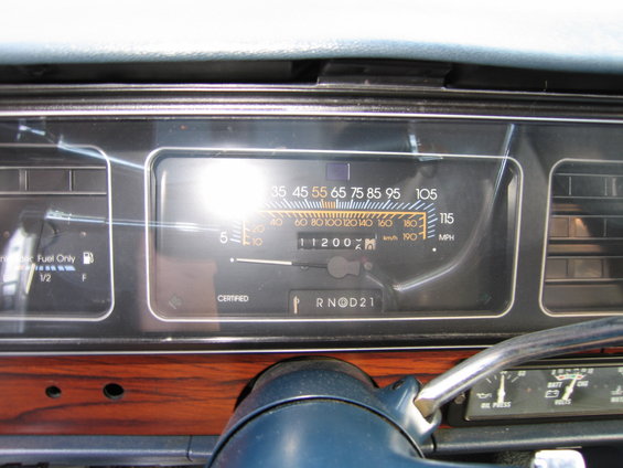 Dashboard interior with speedometer showing 11200 miles and fuel gauge