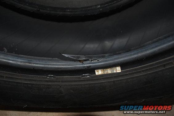 Damaged tire sidewall with a barcode sticker