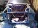 1969 Ford Mustang - The front end of a 1969 Ford Mustang is visible, stripped down and in a state of disrepair.