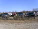 1994 Ford F-250 - Multiple trucks and SUVs are parked in an outdoor lot under a clear blue sky.
