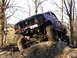 1994 Ford F-250 - This lifted 1994 Ford F-250 navigates a challenging off-road course with its front end angled upwards.