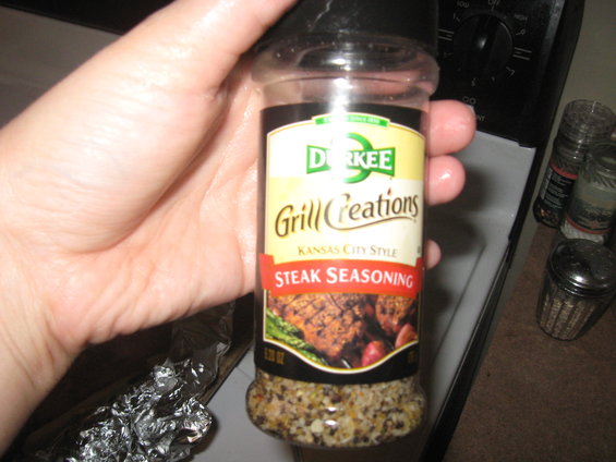 Bottle of Durkee Grill Creations Kansas City Style Steak Seasoning held in hand