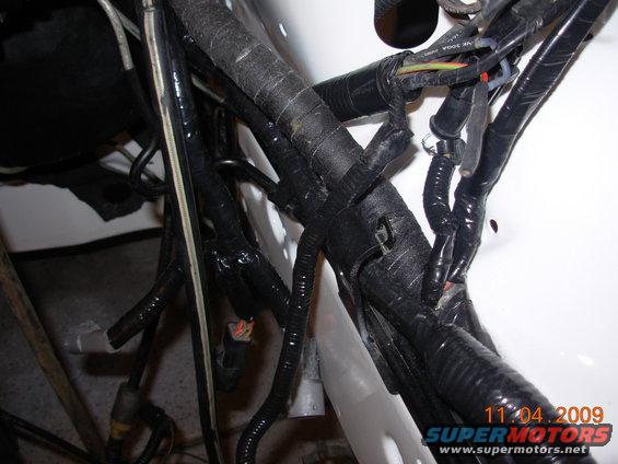Engine wiring harness with black tape and connectors