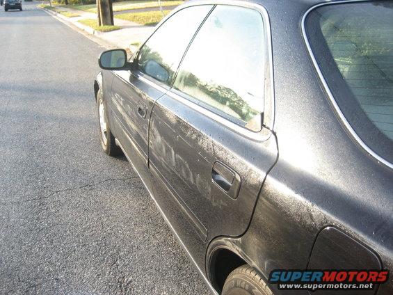 Dark 1997 Acura TL sedan, side view, wet exterior