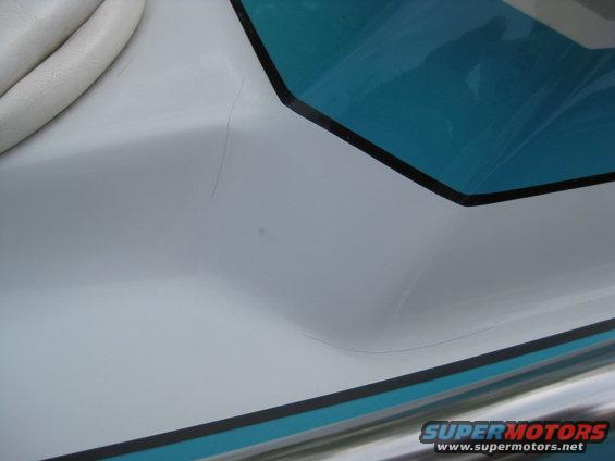 Close-up of white and teal interior of a boat, showing seating and trim
