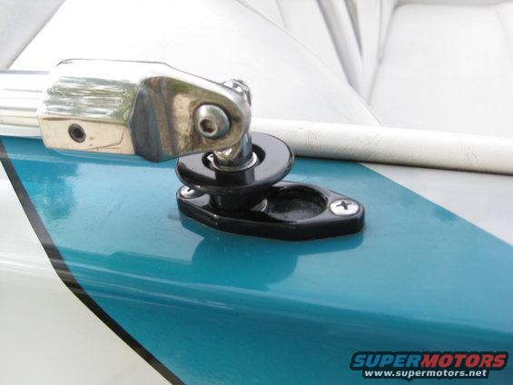 Chrome and black boat hardware attached to a teal and white surface