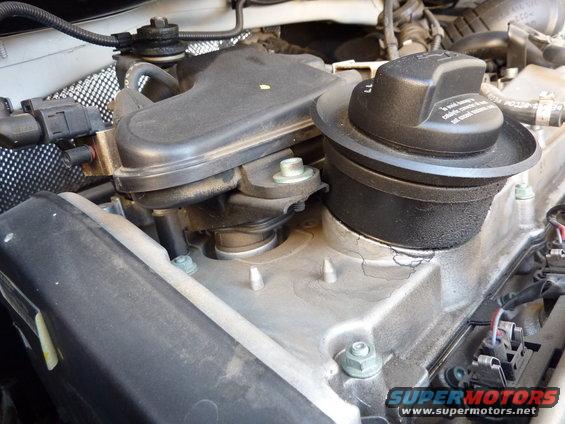 Engine oil cap and surrounding components on a vehicle