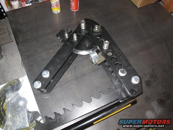 Black tube bender tool with serrated edge and measurement gauge