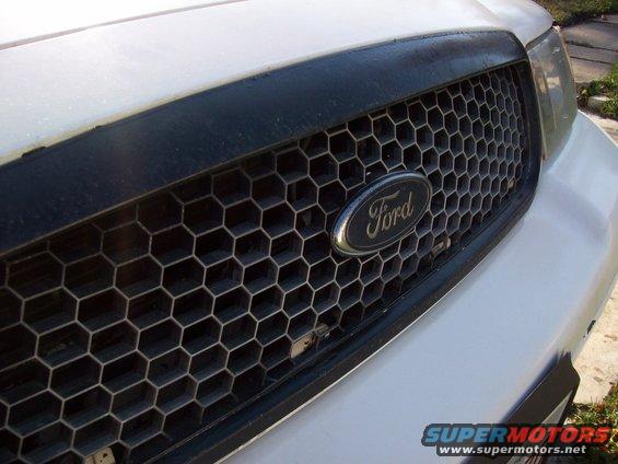 White Ford Crown Victoria grille with honeycomb pattern and Ford logo
