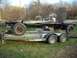 1979 Ford F-250 - A bare truck chassis is transported on a trailer, with a boat visible in the background.