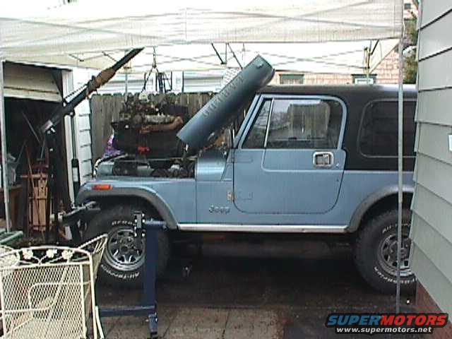 1984 Jeep Wrangler side view, blue with black top, engine out