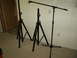 1990 Ford Bronco - Three black microphone stands are arranged indoors, with two on the left and one on the right.