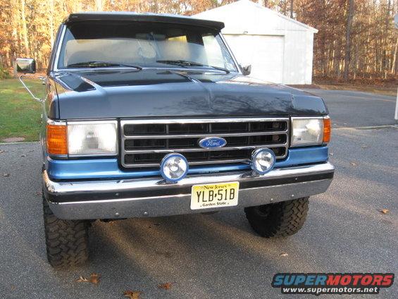 Just finished sandblasting, painting & installing the front valance due to notorious Ford primer problem. Removed 4x4 emblem & filled holes. Cut 4" from the bottom edge of the bumper, removed plastic XLT trim, filled holes, & redid stripe w/Herculiner...narrower than plastic. 
Front grill & rad support flat black.  