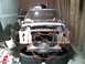 1969 Ford Mustang - The front of a vehicle is disassembled and appears to be undergoing repairs or restoration in a workshop.