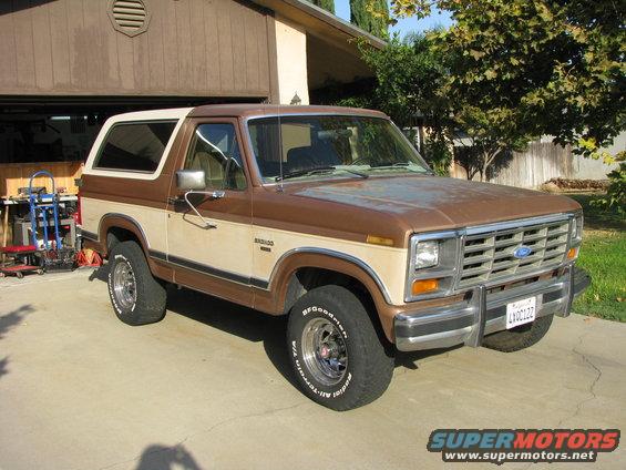 1986 Ford Bronco parked in driveway, brown and tan two-tone paint