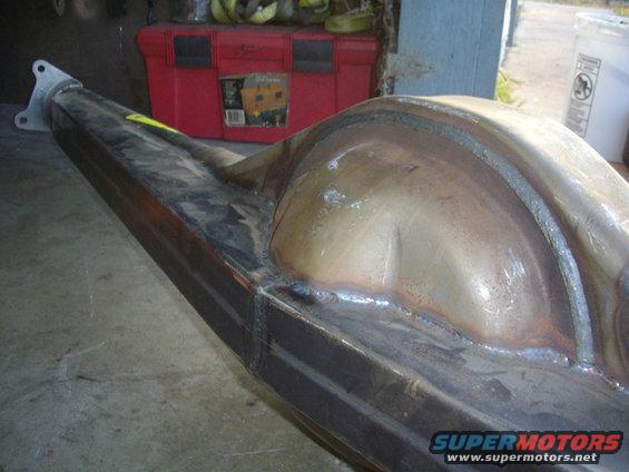 Close-up of a welded rear axle housing with a mounting flange