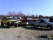 1994 Ford F-250 - Several trucks and a modified Jeep are parked on a gravel lot under a clear blue sky.