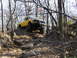 1994 Ford F-250 - Yellow Jeep Comanche pickup truck navigates a challenging rocky off-road course.