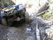 1994 Ford F-250 - This Jeep Cherokee is tackling a challenging muddy obstacle on a wooded trail.