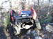 1994 Ford F-250 - Pickup truck with modified bed and large tires is shown off-roading on a rocky hill.