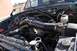 1996 Ford Bronco - The engine bay of a vehicle is shown with various components and hoses.