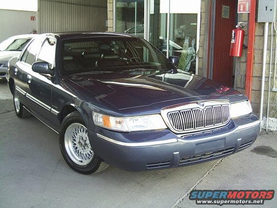 Dark blue Mercury Grand Marquis sedan parked outside a building