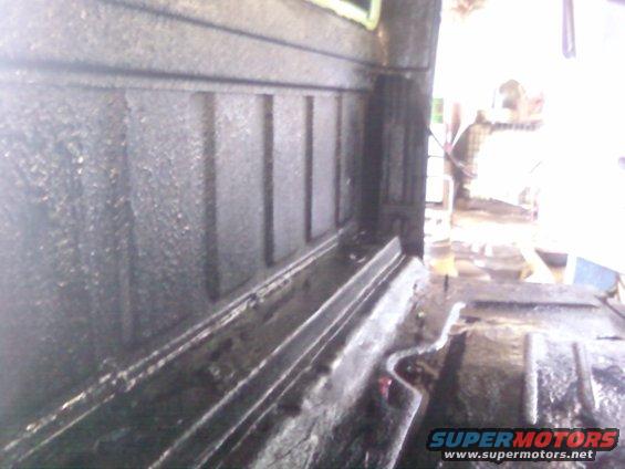 Interior of a truck bed showing textured walls and floor