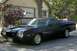1972 Ford Ranchero - Dark blue 1972 Ford Ranchero with a hood scoop parked in front of a garage.
