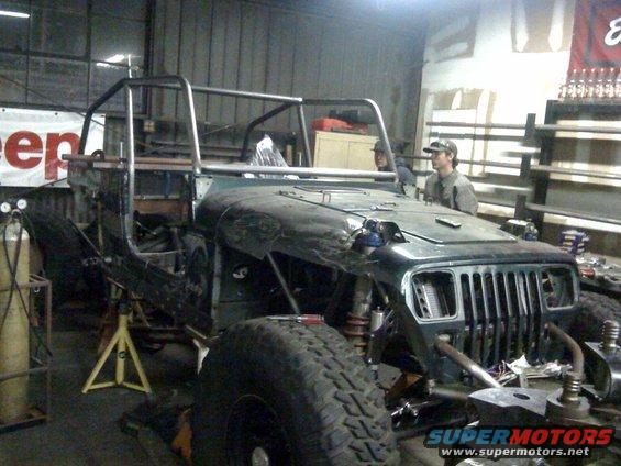 1994 Jeep YJ being modified with a custom roll cage and off-road tires