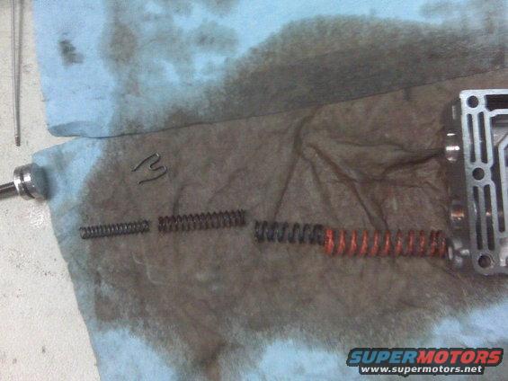 Transmission valve body with springs and a clip laid out on a shop towel