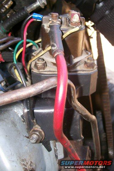 Close-up of starter solenoid and red battery cable with various wires connected
