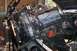 1992 Ford C-350 (Centurion Conversions) - An engine is being worked on, suspended by a hoist in a garage setting.