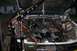 1992 Ford C-350 (Centurion Conversions) - Engine bay of a Ford truck with an engine hoist attached, undergoing maintenance.