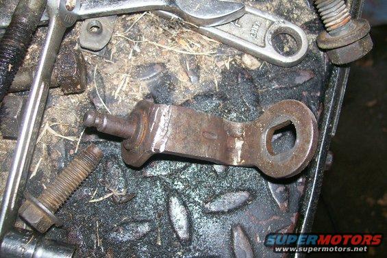 The tranny linkage arm that had to be 'adjusted' to fit around the turbo pipes.  Notice the cracks that formed from me bending it. 