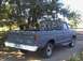 1979 Ford F-250 - This 1979 Ford F-250 pickup truck is seen from the rear, parked outdoors with trees in the background.