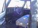 1979 Ford F-250 - The interior of a 1979 Ford F-250 pickup truck, its dashboard, steering wheel, and a patterned bench seat.