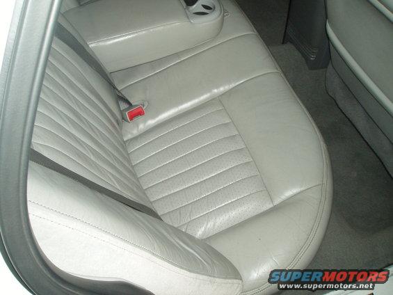 Gray leather rear seat with seatbelt buckle visible