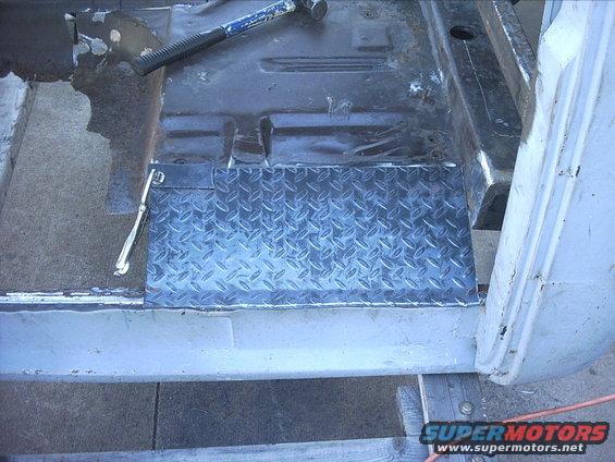 3096478_147_full.jpg 10-31-08:  I used the templates I made yesterday to mark out the cut lines. I started using the shear. It cut great except You can only cut about 7" deep with this shear!   I knew I should have spent the extra money for the throatless shear. :slap Oh well this will work great when I start doing the body work. I'll need to cut out a bunch of small patch panels. Since the shear wasn't going to work for cutting out my floor pieces I dug out the my hand held jigsaw. 

Once I had the panels cut out I clamped the panels between a couple 2"x2" tubes. I clamped the whole thing to the tailgate of my 87 F250. Then I hammered the ends to get a bend in them. Next I checked the panels to make sure they fit.  I clamped the driverside panel to the floor with a vicegrip.