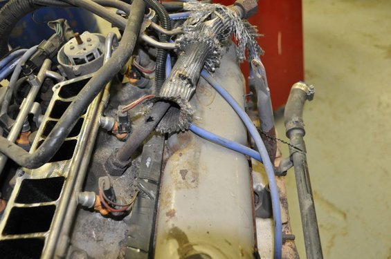 Damaged wiring harness on engine part