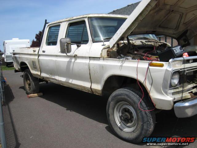 White 1976 Ford F-250 crew cab pickup truck, hood open, showing engine bay