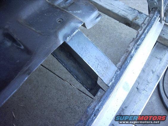 10-30-08:     Well today I started out by doing a little measureing . I needed to extend the floor front crossmember so I could weld it to the rocker plates. So I cut out 4 pieces 1/8" plate. For now I'm just welding a piece of plate on the top and bottom of each of the crossmember ends. When I tip the cab again ( to do the final welding on the bottom of the floors ) I'm going to box the crossmember end exstensions.

I started on the passenger side.