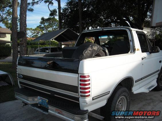 White 1994 Ford Bronco rear view with spare tire in bed